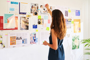 Businesswoman pin photo on board.