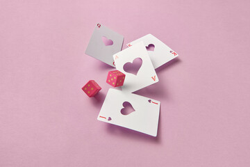 Craft playing cards and pink dice.