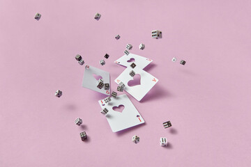 Black and white dice falling with playing cards.