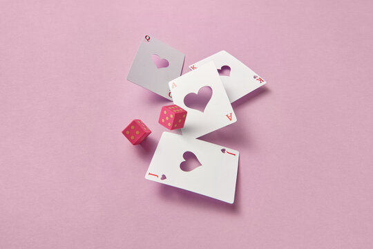 Craft playing cards and pink dice.