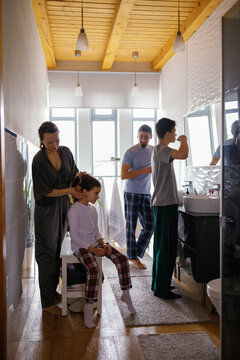 Immediate family mundane bathroom children care brush togetherness 