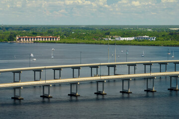 Obraz premium Barron Collier Bridge and Gilchrist Bridge in Florida with moving traffic. Transportation infrastructure in Charlotte County connecting Punta Gorda and Port Charlotte over Peace River