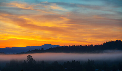 Sunrise with a trail of fog