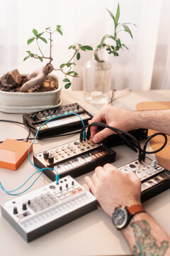 Close Up Of Anonymous Man Making Music With Synthesizers
