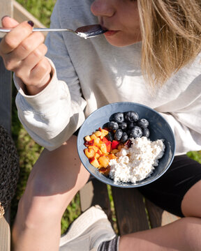 Faceless female enjoying breakfast