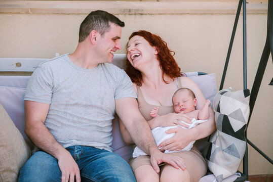 Young Parents with Newborn, Conversations and Laughter in the Patio.