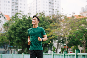 Active and sporty young asian male warming up his body