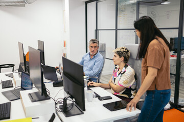 Diverse group of workers working with computers in office