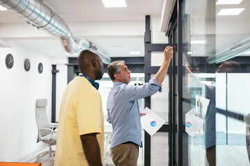Coworkers planning a work project in a modern office