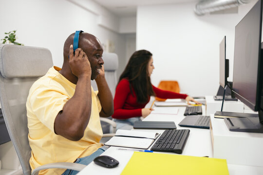 Business black man making a video call with headset in the office