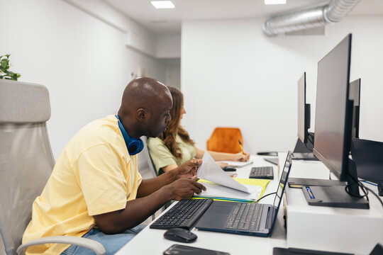 Black man working in company office