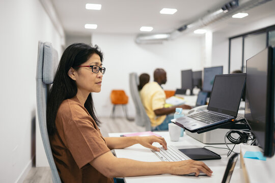 Asian businesswoman working with dual screen in the office