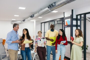 Group portrait of diverse workers in a modern office