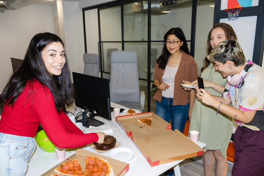 Lo-Fi direct flash photo of coworkers having a party in the office