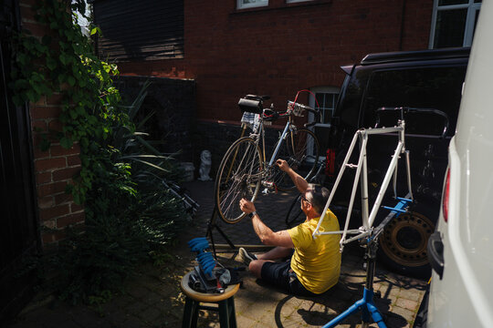 Man repair his bicycle on sunny day