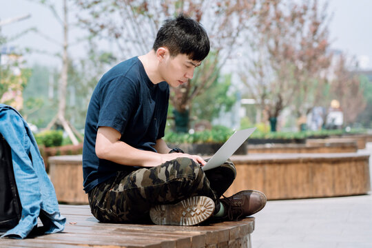 Urban Workspace: Creative Freelancer Thrives with Laptop Outdoors