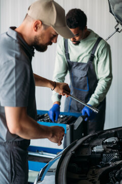 Two Mechanics Repairing Car