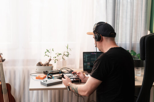 Anonymous Man Making Music On Synthesizers In His Music Studio