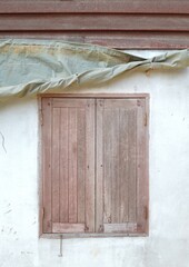 old wooden window with a white brick wall