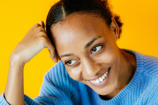 African happy woman over yellow background