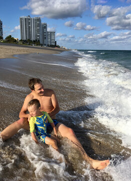 family enjoy ocean waves

