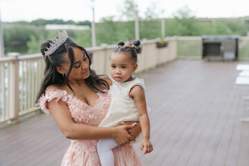 teen girl holding baby sister during her quinceanera