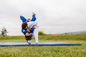 Teenagers training judo in park
