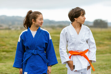 Teens in judo uniform gi outdoors