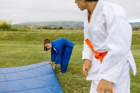 Judokas placing tatami outdoor