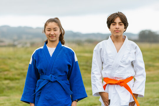 Diverse judokas posing in nature