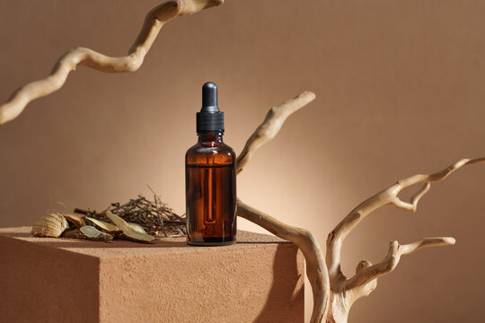 Essential oil dropper with driftwood. Cosmetic mockup