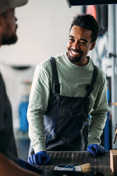 Two Workers in Car Garage 