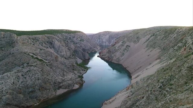 Tourist standing on the edge of the Zrmanja canyon which is very risky to climb in Jasenice, Zadar County, Croatia. View from Pueblo VinetuPariževačpuebloka.