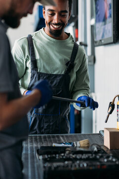 Two Workers in Car Garage 