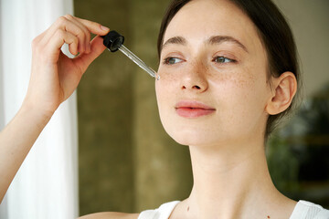 Attractive Model Using Face Serum Dropper