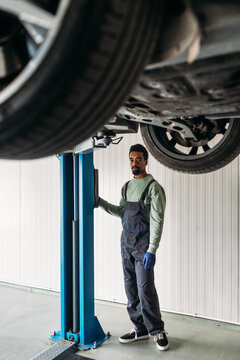 Mechanic Checking Car Tire Condition 