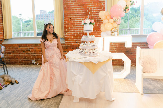 teenager cutting cake during Quinceneara
