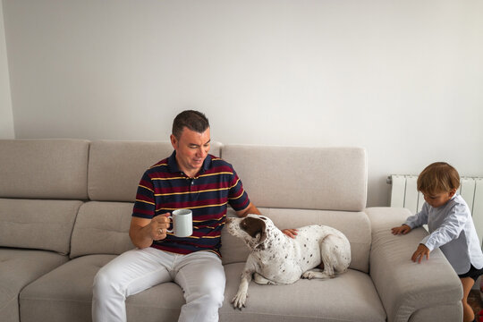 father with his little son and dog at home