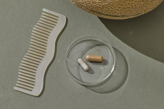 Wavy Comb and Supplement Pills on Sage Background