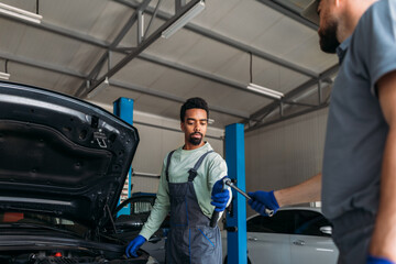 Two Mechanics Repairing Car