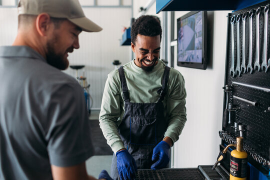 Two Workers in Car Garage 