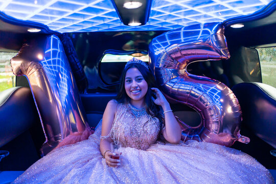 Portrait Of A Happy Quinceanera Girl's Birthday Party In A Limousine. 