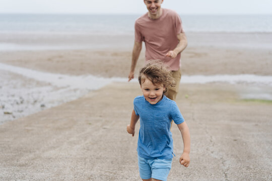 Little boy with his father on the beach