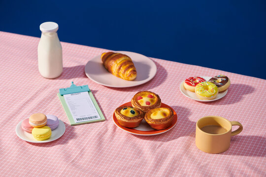 tea time and egg tart and donut on wooden table