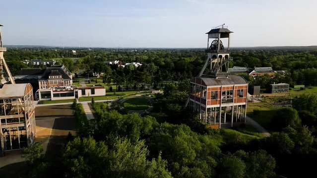 Old mining shaft complex towers in Genk, aerial drone view