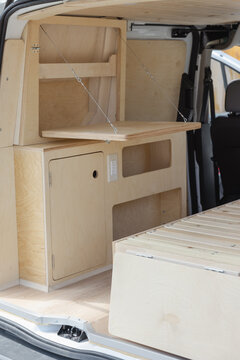 after of a minimalist van build out with light birch wood