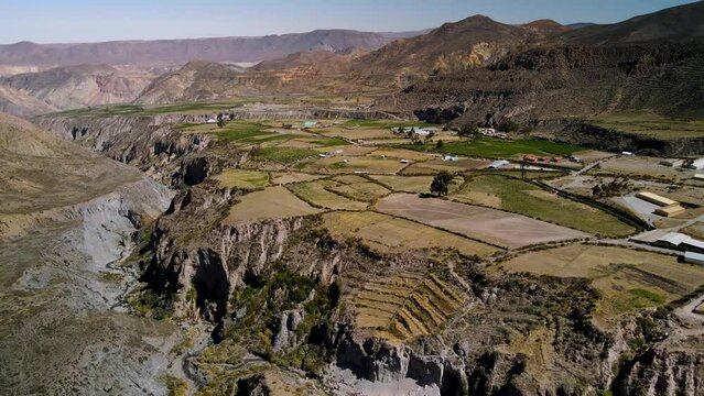 Aerial view towards small town in the altiplano, sunny evening, Putre,  Chile - forward, drone shot
