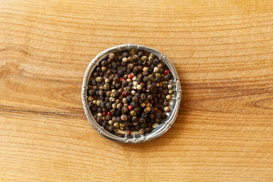 Before and after shot of peppercorns and ground pepper