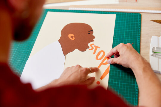Cropped image of artist creating activist poster