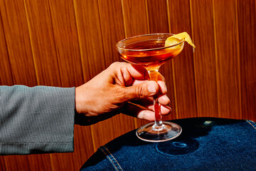 man with a Martinez cocktail in his hand